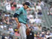 Seattle Mariners pitcher Logan Gilbert reacts after giving up his seventh run during the fourth inning of a baseball game, Thursday, May 9, 2024, in Minneapolis.