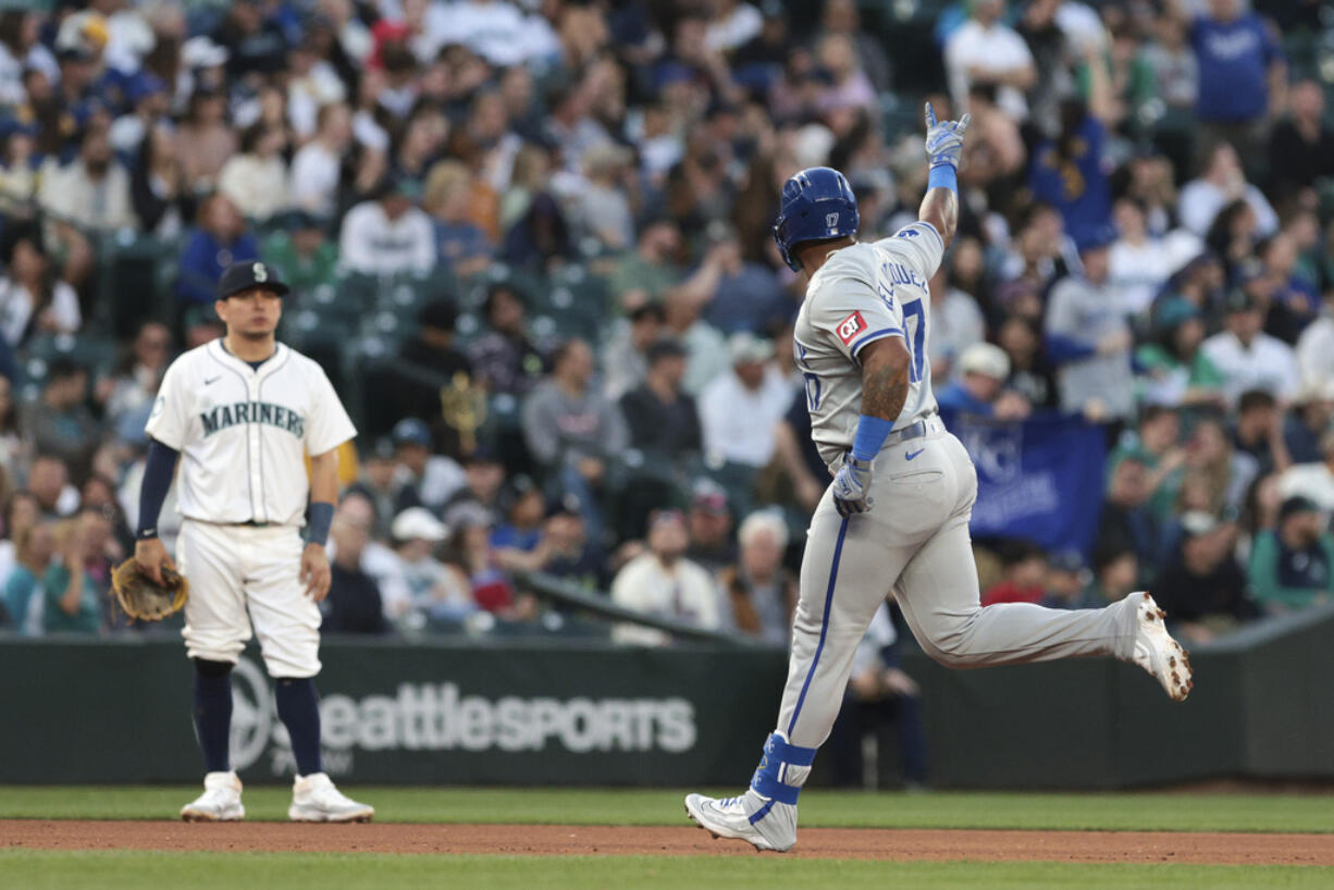 Kansas City Royals' Nelson Velazquez, right, runs the bases after hitting a three-run home run, while Seattle Mariners third baseman Luis Urias watches during the seventh inning of a baseball game Tuesday, May 14, 2024, in Seattle.