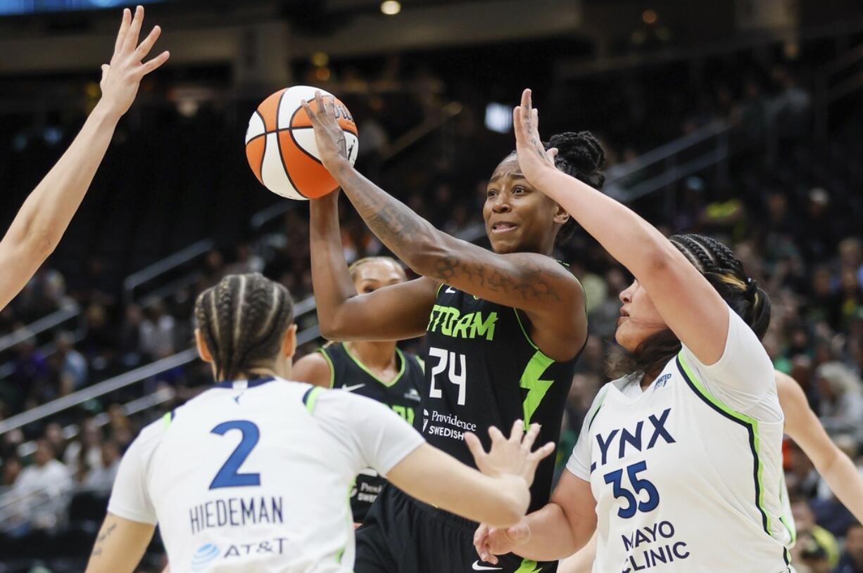Seattle Storm guard Jewell Loyd passes the ball against the Minnesota Lynx defense during the first quarter of a WNBA basketball game Tuesday, May 14, 2024, in Seattle.