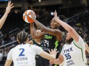 Seattle Storm guard Jewell Loyd passes the ball against the Minnesota Lynx defense during the first quarter of a WNBA basketball game Tuesday, May 14, 2024, in Seattle.