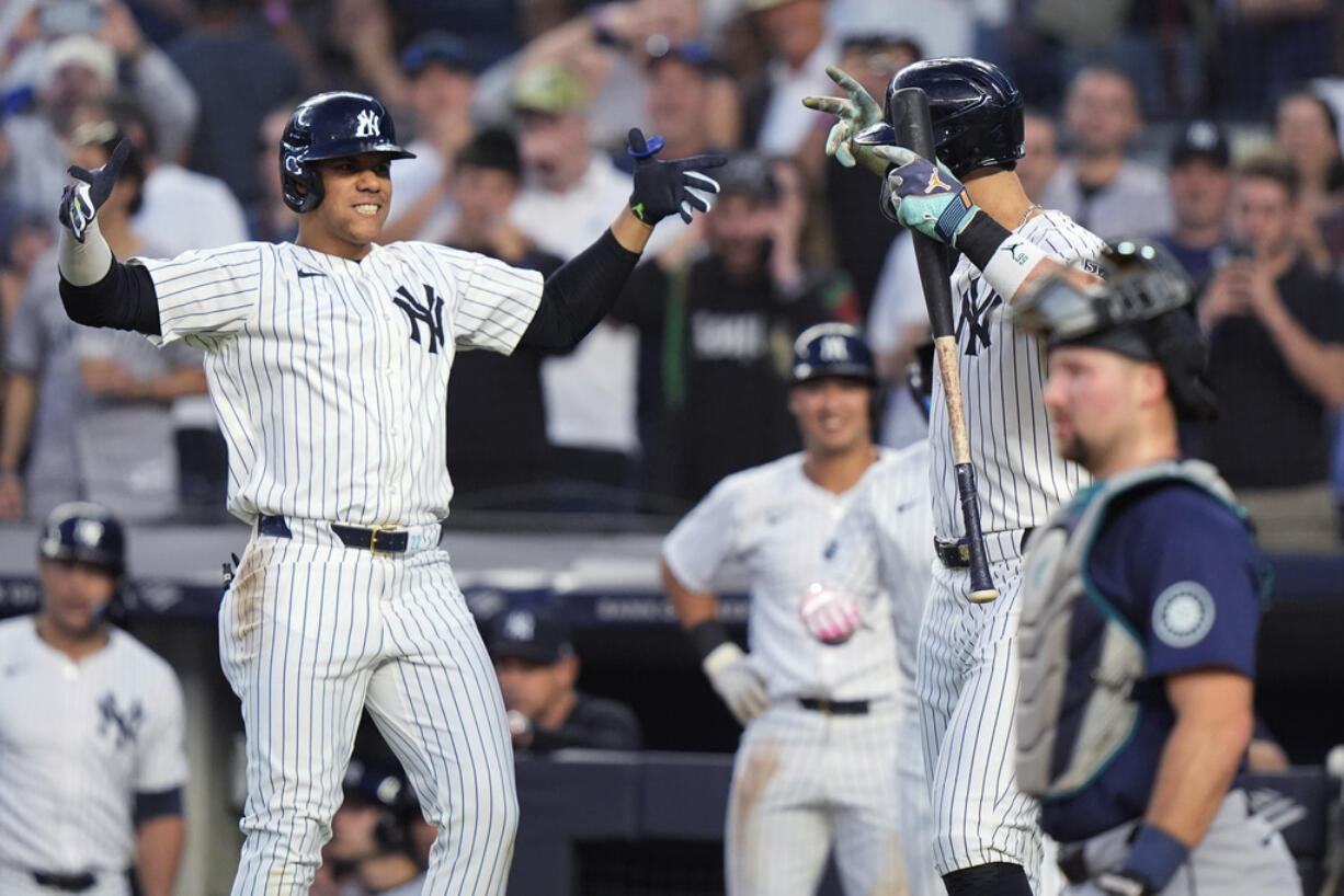 New York Yankees' Juan Soto, left, celebrates with Aaron Judge after hitting a two-run home run against the Seattle Mariners during the third inning of a baseball game Wednesday, May 22, 2024, in New York.