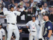 New York Yankees' Juan Soto, left, celebrates with Aaron Judge after hitting a two-run home run against the Seattle Mariners during the third inning of a baseball game Wednesday, May 22, 2024, in New York.
