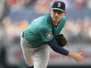 Seattle Mariners starting pitcher George Kirby follows through during the first inning of a baseball game against the Washington Nationals, Friday, May 24, 2024, in Washington.