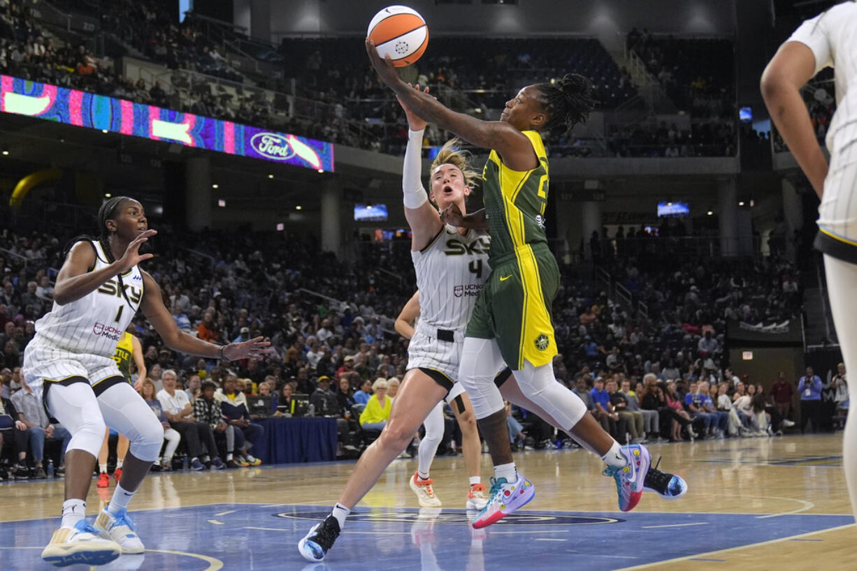 Chicago Sky guard Marina Mabrey, left, fouls Seattle Storm guard Jewell Loyd during the first half of a WNBA basketball game Tuesday, May 28, 2024, in Chicago.