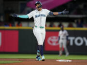 Seattle Mariners' Julio Rodríguez reacts after hitting an RBI single and reaching second base on a throwing error by Houston Astros third baseman Alex Bregman during the eighth inning of a baseball game Tuesday, May 28, 2024, in Seattle.