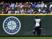 Seattle Mariners center fielder Julio Rodríguez can't catch a long fly ball hit by Houston Astros' Alex Bregman for a triple during the sixth inning of a baseball game, Thursday, May 30, 2024, in Seattle.
