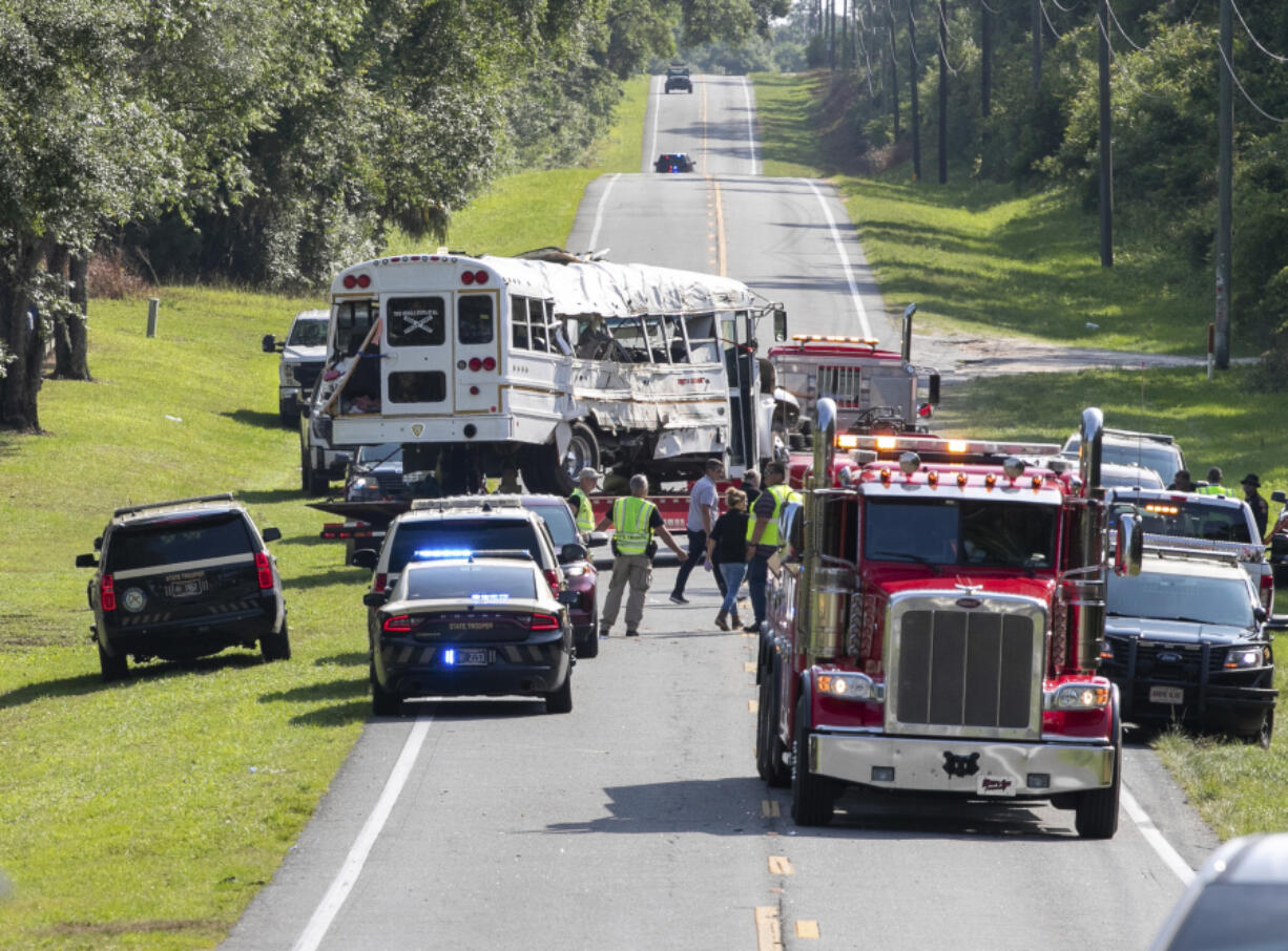 Authorities work at the scene of a deadly crash after a bus carrying farmworkers collided with a pickup truck on State Road 40 Tuesday, May 14, 2024, near Dunnellon, Fla. The driver of the pick up, Bryan Maclean Howard, was charged with eight counts of DUI manslaughter.