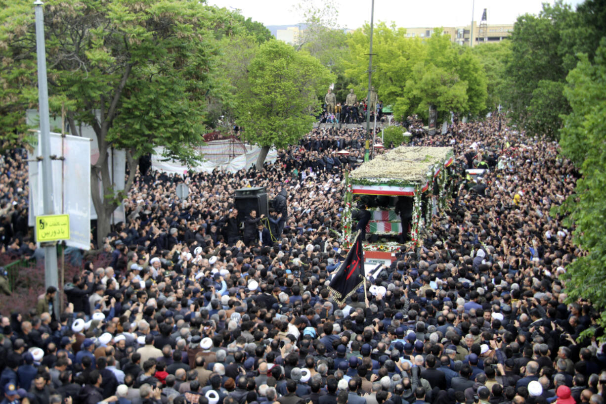 In this photo provided by Fars News Agency, mourners gather around a truck carrying coffins of Iranian President Ebrahim Raisi and his companions who were killed in a helicopter crash on Sunday in a mountainous region of the country&rsquo;s northwest, during a funeral ceremony at the city of Tabriz, Iran, Tuesday, May 21, 2024. Mourners in black began gathering Tuesday for days of funerals and processions for Iran&rsquo;s late president, foreign minister and others killed in a helicopter crash, a government-led series of ceremonies aimed at both honoring the dead and projecting strength in an unsettled Middle East.