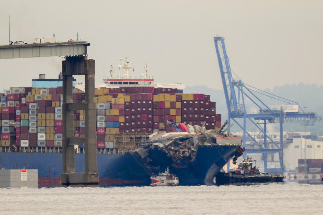 Tugboats escort the cargo ship Dali after it was refloated in Baltimore, Monday, May 20, 2024. The vessel struck the Francis Scott Key Bridge on March 26 causing it to collapse and resulting in the death of six people.