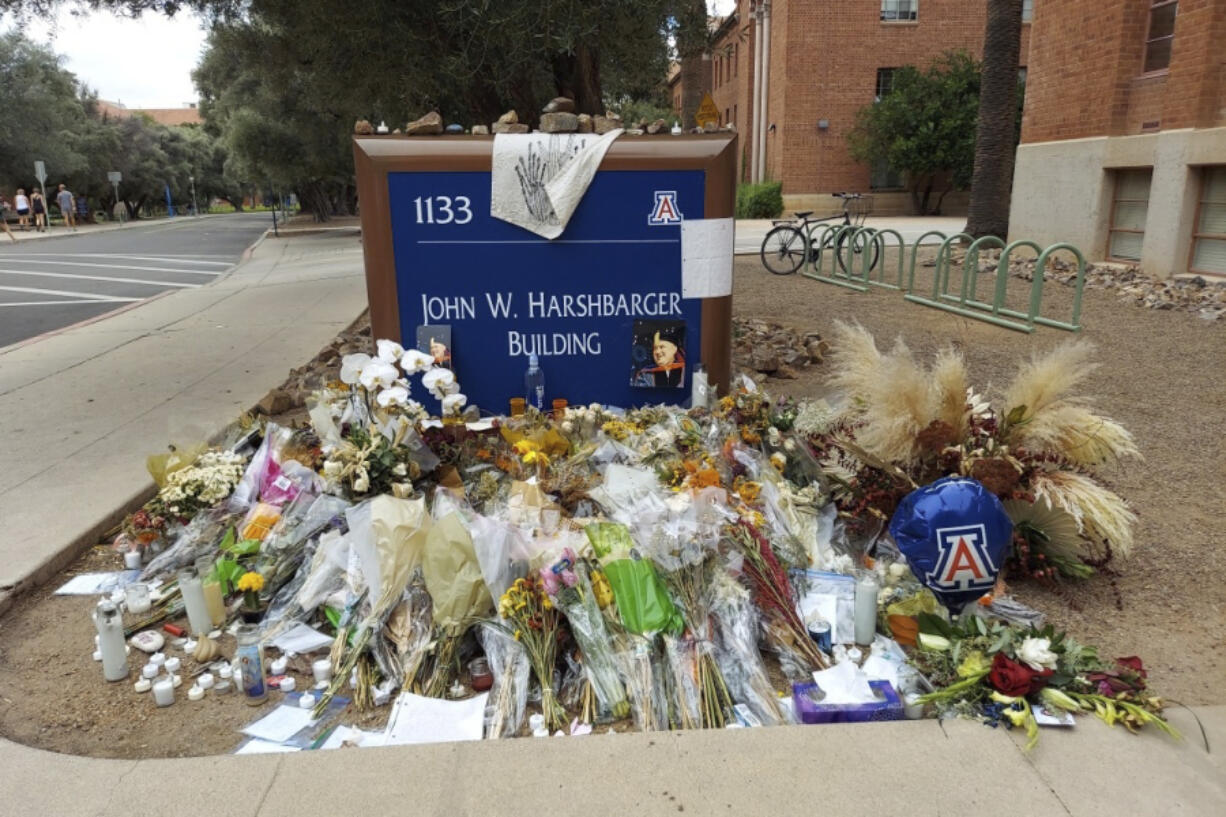 FILE - A memorial for University of Arizona professor Thomas Meixner is seen outside the school&rsquo;s Department of Hydrology and Atmospheric Sciences building in Tucson, Ariz., Oct. 14, 2022. A jury was seated Tuesday, May 7, 2024, for the trial of a former University of Arizona graduate student accused of fatally shooting Meixner in 2022 after he was banned from campus because of harassment complaints.