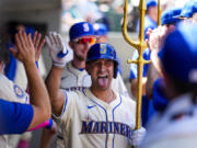 Seattle Mariners&#039; Seby Zavala sticks out his tongue as he holds a trident in the dugout while celebrating his solo home run against the Oakland Athletics during the sixth inning of a baseball game Sunday, May 12, 2024, in Seattle.