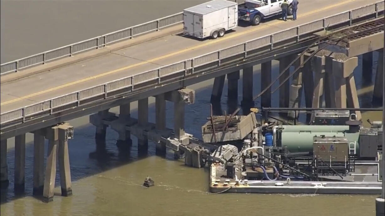 Oil spills into the surrounding waters after a barge hit a bridge in Galveston, Texas, on Wednesday, May 15, 2024.