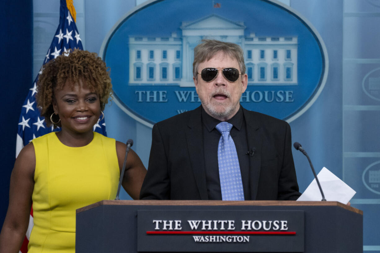 Actor Mark Hamill, right, joins White House press secretary Karine Jean-Pierre as she speaks with reporters in the James Brady Press Briefing Room at the White House, Monday, April 15, 2024, in Washington.