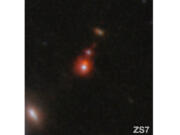 The ZS7 galaxy system, revealing the ionized hydrogen emission in orange and the doubly ionized oxygen emission in dark red.