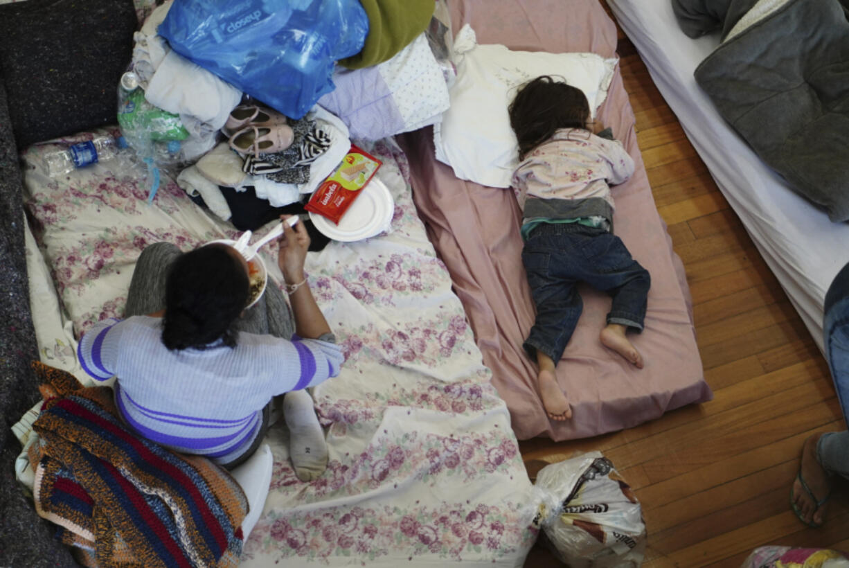 People rest in a shelter after their homes were flooded by heavy rains in Porto Alegre, Rio Grande do Sul state, Brazil, Saturday, May 4, 2024.
