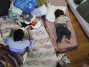 People rest in a shelter after their homes were flooded by heavy rains in Porto Alegre, Rio Grande do Sul state, Brazil, Saturday, May 4, 2024.