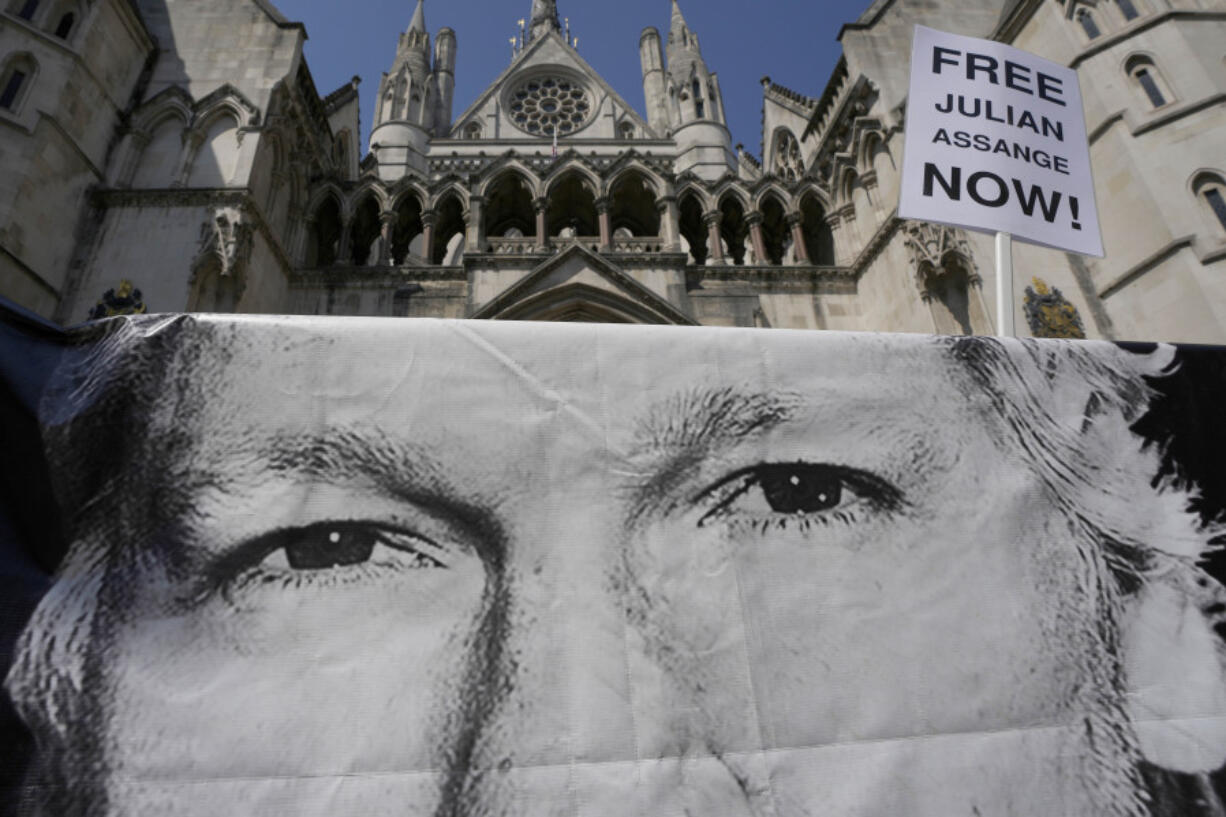 A poster of Julian Assange is left by protesters outside the High Court in London, Monday, May 20, 2024. A British court has ruled that WikiLeaks founder Julian Assange can appeal against an order that he be extradited to the U.S.