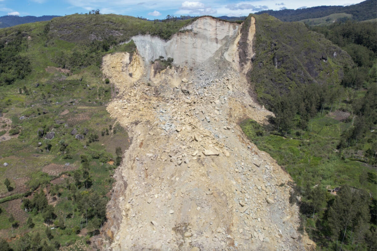 In this image taken from video, drone footage shows a landslide in Yambali village, in the Highlands of Papua New Guinea, Monday, May 27, 2024. Emergency responders say that up to 8,000 people might need to be evacuated as the mass of boulders, earth and splintered trees that crushed the village of Yambali in the nation&rsquo;s mountainous interior on Friday, May 24 becomes increasingly unstable.