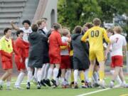 Camas boys soccer players celebrate after capturing a 3-2 win over Pasco in the Class 4A state boys soccer semifinals on Friday, May 24, 2024, at Sparks Stadium in Puyallup.