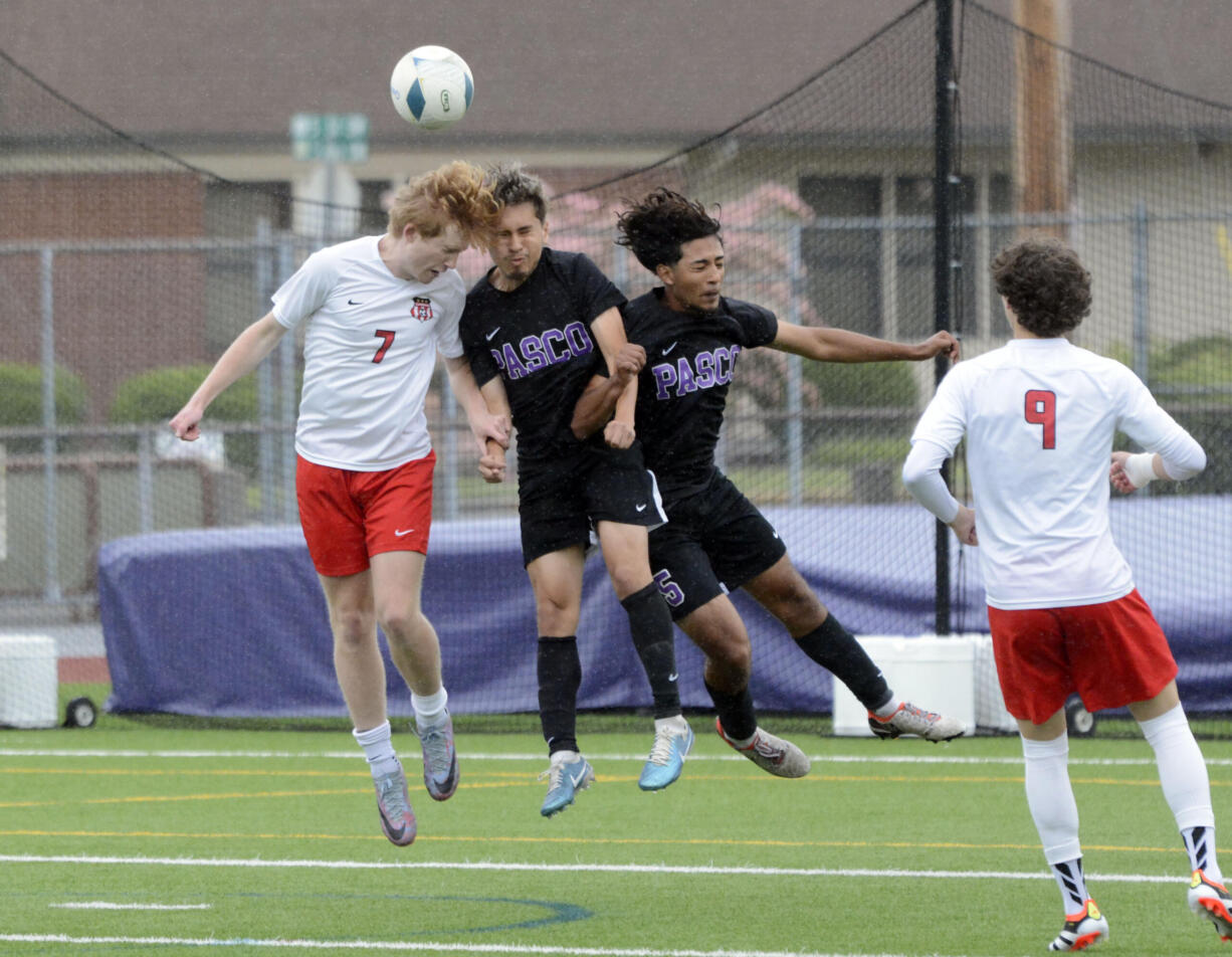 Camas' Markku Laukkanen (7) attempts to head the ball against multiple Pasco defenders during the Class 4A state boys soccer semifinals on Friday, May 24, 2024, at Sparks Stadium in Puyallup.