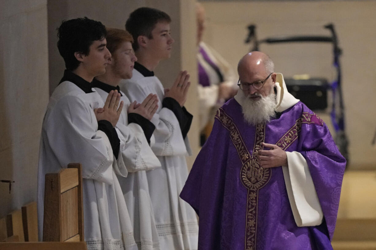 Rev. Gabriel Landis officiates a Catholic Mass at Benedictine College Sunday, Dec. 3, 2023, in Atchison, Kan.