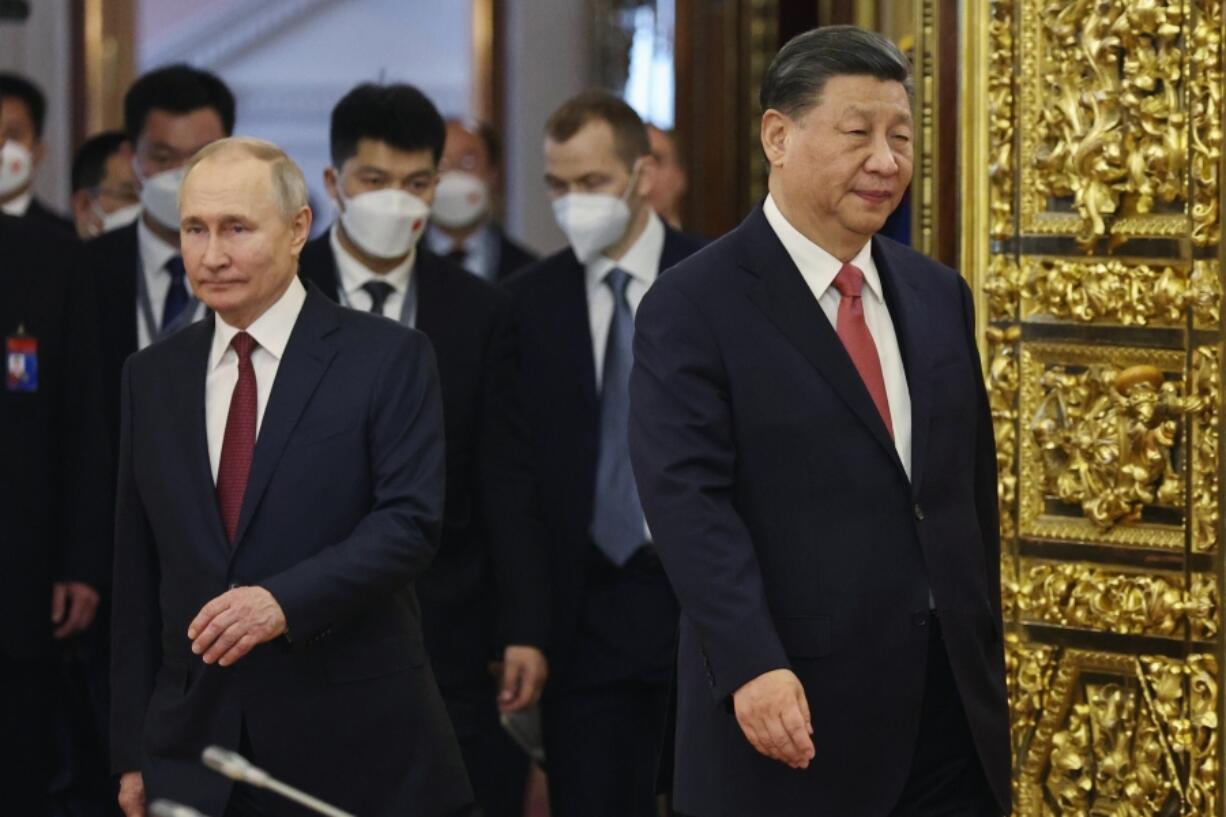 FILE - Russian President Vladimir Putin, left, and Chinese President Xi Jinping enter a hall for their talks at The Grand Kremlin Palace, in Moscow, Russia, on March 21, 2023. Putin says his regime is prepared to negotiate over the conflict in Ukraine in an interview with Chinese media on the eve of visit to partner Beijing that has backed Moscow in its full-scale invasion of its neighbor.