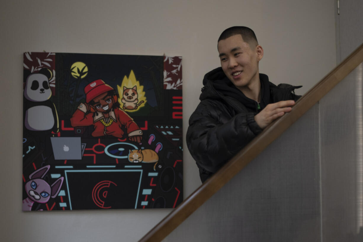Chinese rapper Haysen Cheng reacts March 16 near a painting depicting a rapper at this studio in Chengdu in southwestern China&rsquo;s Sichuan province.