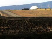 Burnt grass is seen June 30, 2000, after a wildfire near the Fast Flux Test Reactor on the Hanford nuclear reservation near Richland.