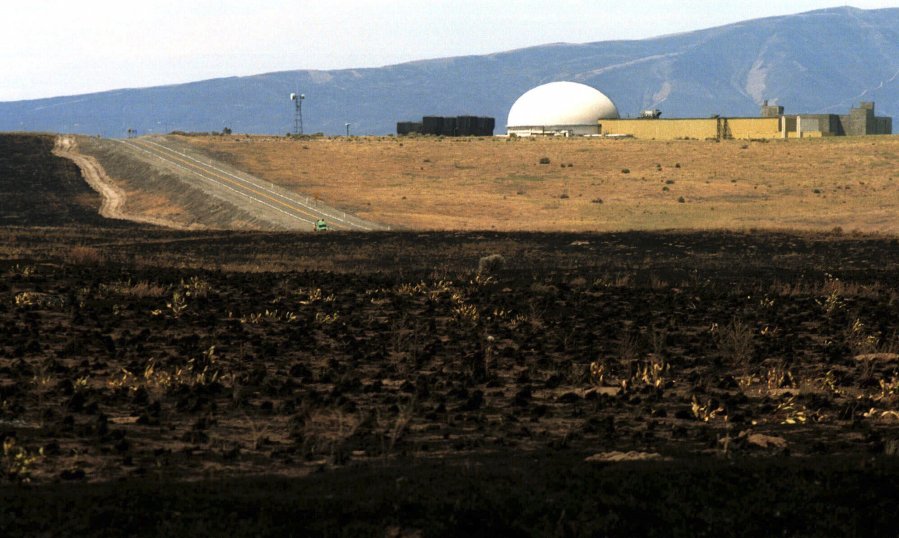 Burnt grass is seen June 30, 2000, after a wildfire near the Fast Flux Test Reactor on the Hanford nuclear reservation near Richland.