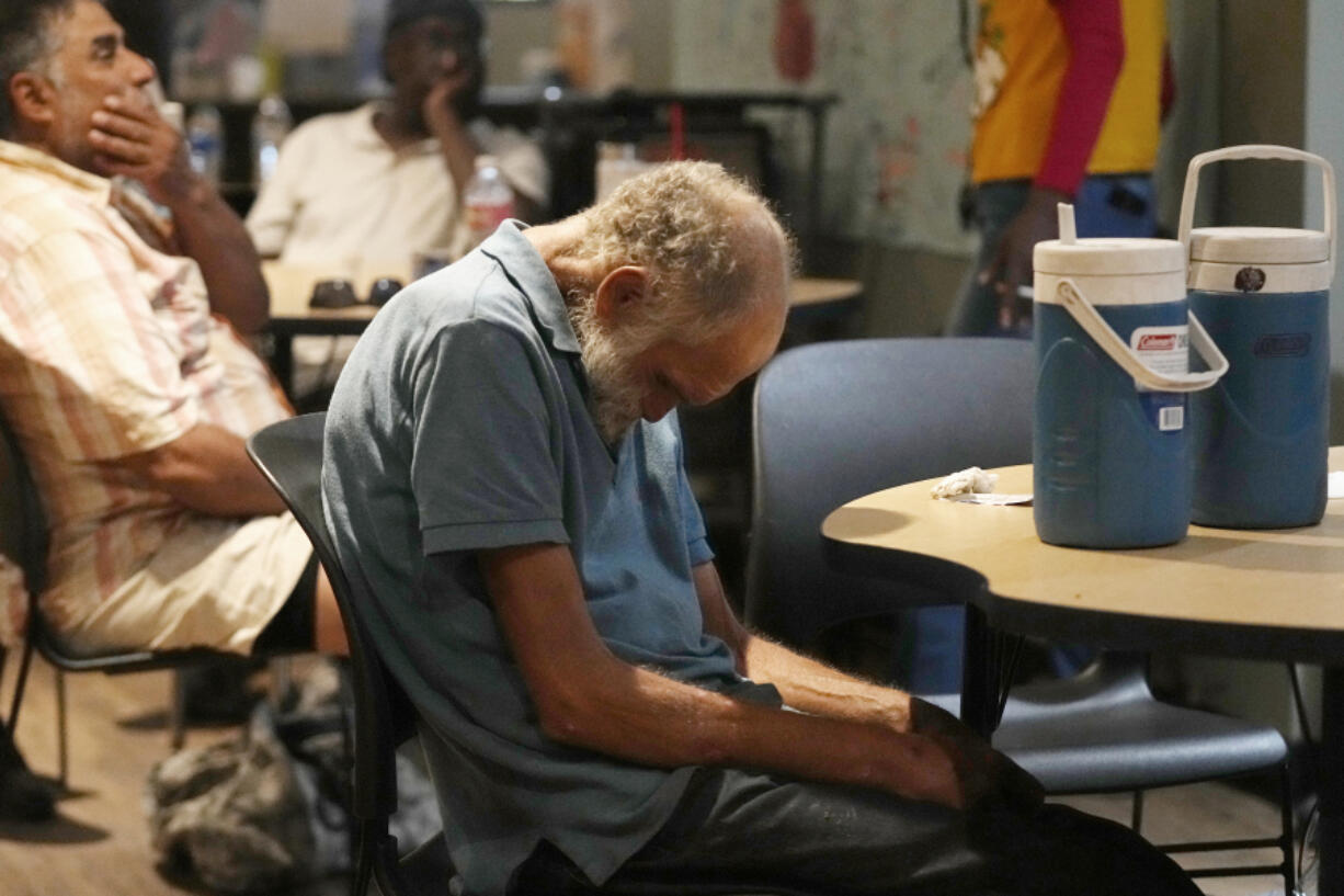 FILE - Patrons try to cool off inside at the Justa Center as temperatures are expected to hit 116 degrees Fahrenheit, on July 18, 2023, in Phoenix. The death certificates of more than 2,300 people who died in the United States last summer mention the effects of excessive heat, the highest number in 45 years of records, according to an Associated Press analysis of Centers for Disease Control and Prevention data. With May already breaking heat records, 2024 could be even deadlier. (AP Photo/Ross D.