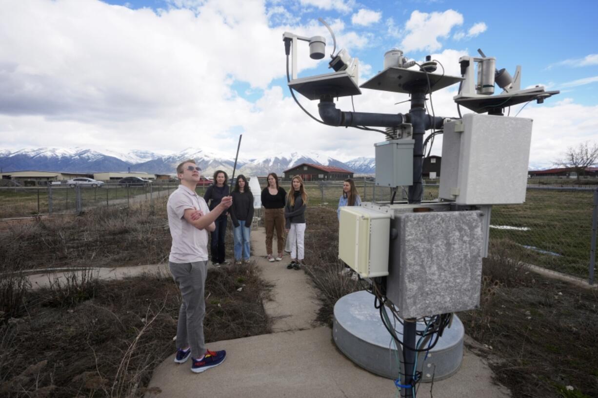 Climate Data Analyst Casey Olson, left, of Utah State University, conducts a tour during a visit to the Utah Climate Center&rsquo;s climate reference station on April 1, 2024, in Logan, Utah. Increasingly, U.S. universities are creating climate change programs to meet demand from students who want to apply their firsthand experience to what they do after high school.