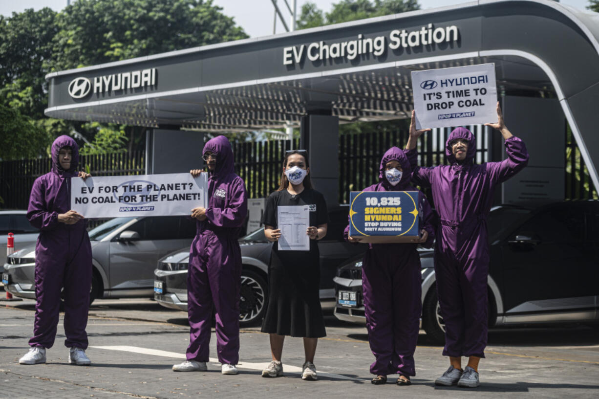 Kpop4Planet members demonstrate as part of a Hyundai, Drop Coal protest outside Hyundai Motorstudio Senayan Park in Jakarta.