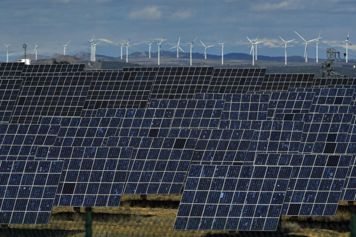 FILE - Solar panels work near the small town of Milagro, Navarra Province, northern Spain, Feb. 24, 2023. Billions of people are using different kinds of energy each day and 2023 was a record-breaking year for renewable energy sources, according to a report published Wednesday, May 8, 2024, by Ember, a think tank based in London.