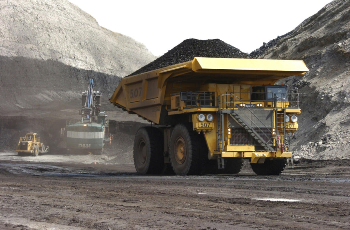 A truck carrying 250 tons of coal hauls the fuel to the surface of the Spring Creek mine, April 4, 2013, near Decker, Mont. The Biden administration is proposing to end new coal leases from federal lands in the Powder River Basin of Montana and Wyoming, which includes Spring Creek.