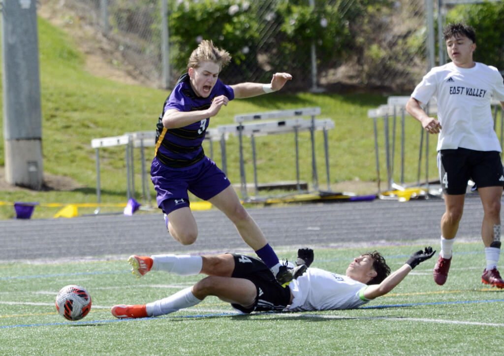 Columbia River's Alex Pont (9) falls to the turf after East Valley's Gavin Gordon (14) slides in for a tackle during the Class 2A boys soccer state quarterfinals on Saturday, May 18, 2024, at Columbia River High School.