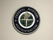 FILE - A Federal Aviation Administration sign hangs in the tower at John F. Kennedy International Airport in New York, March 16, 2017. Congressional negotiators have agreed on a $105 billion bill designed to improve the safety of air travel after a series of close calls between planes at the nation&rsquo;s airports.