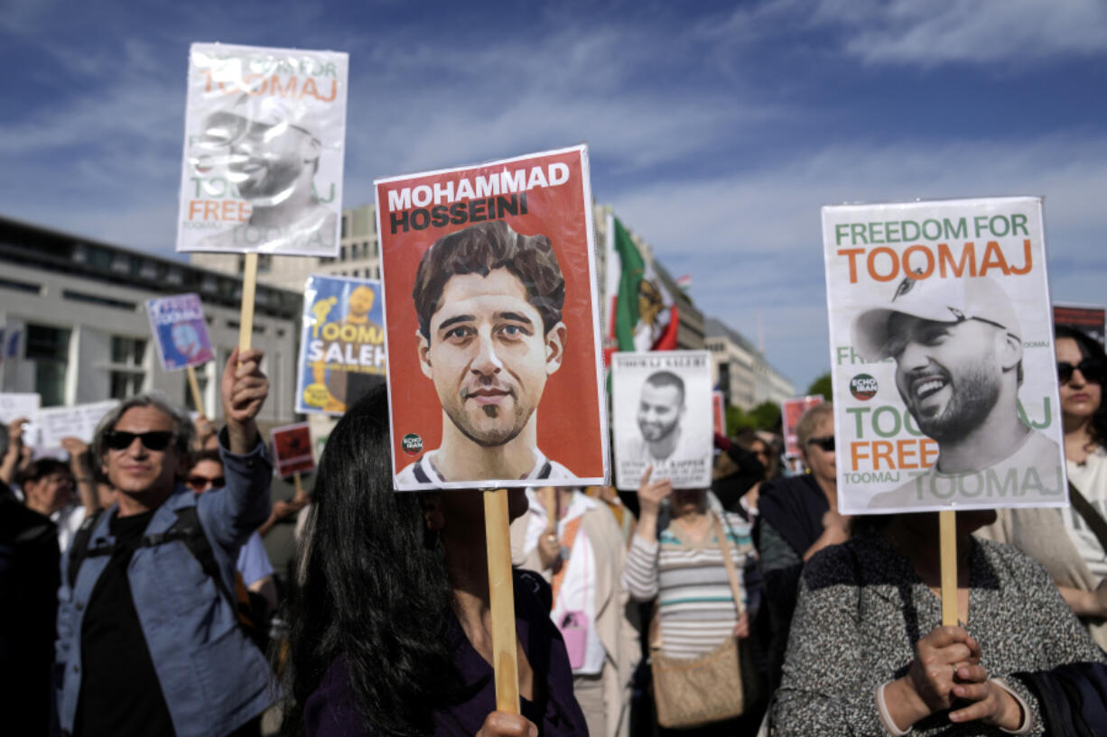 FILE - Protesters attend a rally against a death sentence given to a popular rapper in Iran and to support to the women of Iran, in Berlin, Germany, April 28, 2024. Lawmakers are introducing legislation targeting Iranian officials involved in the prosecution and planned execution of rapper Toomaj Salehi, who rose to fame with lyrics about the 2022 death of Mahsa Amini and for criticism of the Islamic Republic.