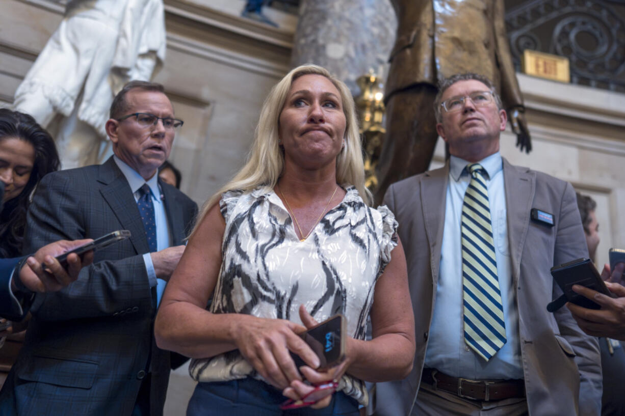 Rep. Marjorie Taylor Greene, R-Ga., joined by Rep. Thomas Massie, R-Ky., right, speaks to reporters following a lengthy meeting with House Speaker Mike Johnson, R-La., whom she has vowed to remove from his leadership post, at the Capitol in Washington, Monday, May 6, 2024. (AP Photo/J.