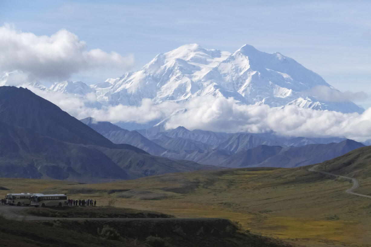 FILE - Sightseeing buses and tourists are seen at a pullout popular for taking in views of North America&rsquo;s tallest peak, Denali, in Denali National Park and Preserve, Alaska, Aug. 26, 2016. Two climbers awaited rescue near the peak of North America&rsquo;s tallest mountain Wednesday, May 29, 2024, a day after they and a third climber in their team requested help after summiting Denali during the busiest time of the mountaineering season, officials at Denali National Park and Preserve said.