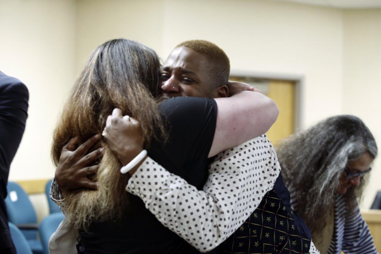 Eric Posey of Post Falls, Idaho, embraces a supporter in court, after a jury awarded him more than $1.1 million in damages in his defamation lawsuit against conservative blogger Summer Bushnell, Friday, n Coeur D'Alene, Idaho. Posey said he suffered harassment and death threats after Bushnell falsely accused him of exposing himself to minors during a performance in 2022.