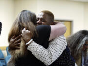 Eric Posey of Post Falls, Idaho, embraces a supporter in court, after a jury awarded him more than $1.1 million in damages in his defamation lawsuit against conservative blogger Summer Bushnell, Friday, n Coeur D'Alene, Idaho. Posey said he suffered harassment and death threats after Bushnell falsely accused him of exposing himself to minors during a performance in 2022.