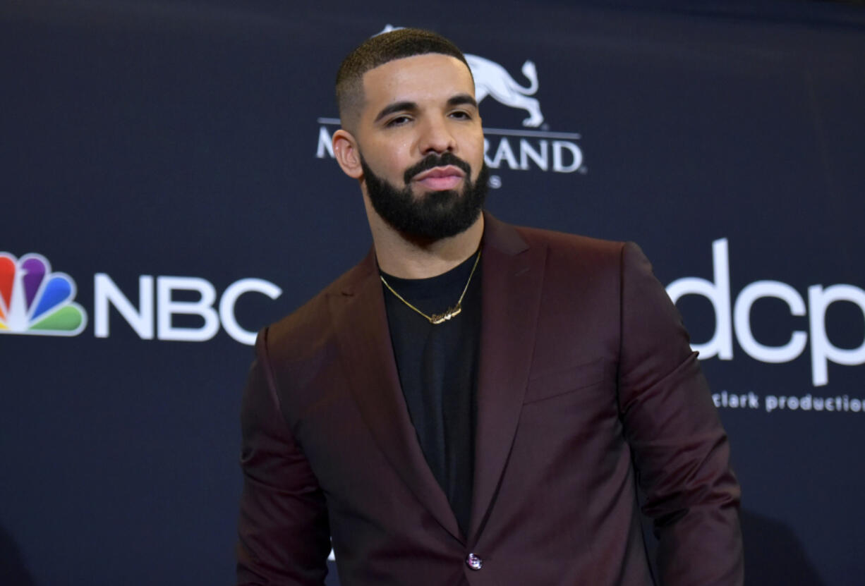 FILE - Drake poses at the Billboard Music Awards in Las Vegas on May 1, 2019. Police are investigating a shooting outside rapper Drake&rsquo;s mansion that left a security guard seriously wounded. Authorities did not confirm whether Drake was at home at the time of the shooting, but said his team is cooperating. The shooting happened around 2 a.m. Tuesday in the affluent Bridle Path neighborhood of Toronto.