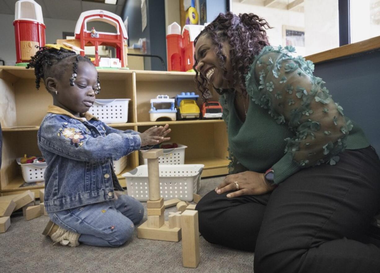 Zaneta Billyzone-Jatta smiles at her two-year-old daughter, Zakiah Jatta, in her classroom at Akin&rsquo;s Early Learning Center on March 26 in Auburn. Zakiah is enrolled in Washington&rsquo;s ECEAP (Early Childhood Education and Assistance Program). (ellen m.
