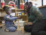 Zaneta Billyzone-Jatta smiles at her two-year-old daughter, Zakiah Jatta, in her classroom at Akin&rsquo;s Early Learning Center on March 26 in Auburn. Zakiah is enrolled in Washington&rsquo;s ECEAP (Early Childhood Education and Assistance Program). (ellen m.