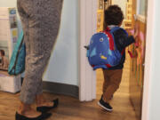 A young boy enters the toddler room with his mother at the KinderCare Child Development Center at The Venetian Resort Las Vegas April 18, 2024.