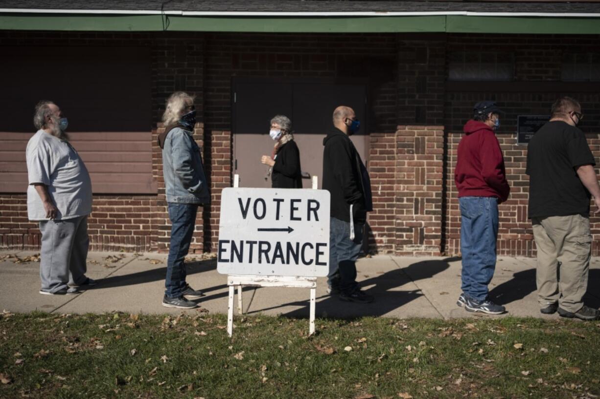 FILE - Voters wait in line outside a polling center on Election Day, Nov. 3, 2020, in Kenosha, Wis. A Democratic group is rolling out a new $140 million ad campaign this week that aims to chip away at Donald Trump&#039;s support among one of his most loyal voting blocs: rural voters. The ads from American Bridge 21st Century will begin airing Monday, May 13, 2024, in the northern battleground states of Pennsylvania, Michigan and Wisconsin.