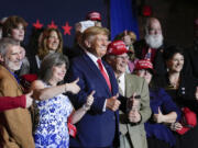 FILE - Former President Donald Trump poses for a photo with supporters after speaking at a campaign event Thursday, April 27, 2023, in Manchester, N.H. He&rsquo;s a criminal defendant, a businessman and a politician. But to his most loyal supporters, Donald Trump will always be Mr. President. When it comes to signaling our political loyalities, language can be just as telling as a MAGA cap, offering a simple by subtle reminder of the false election claims that continue to reverberate online, as well as the polarization that has gripped our politics and divided our people.