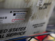 FILE - Vote-by-mail ballots for the presidential primary election are seen on March 12, 2024, at the Clark County Elections Office in Vancouver, Wash.