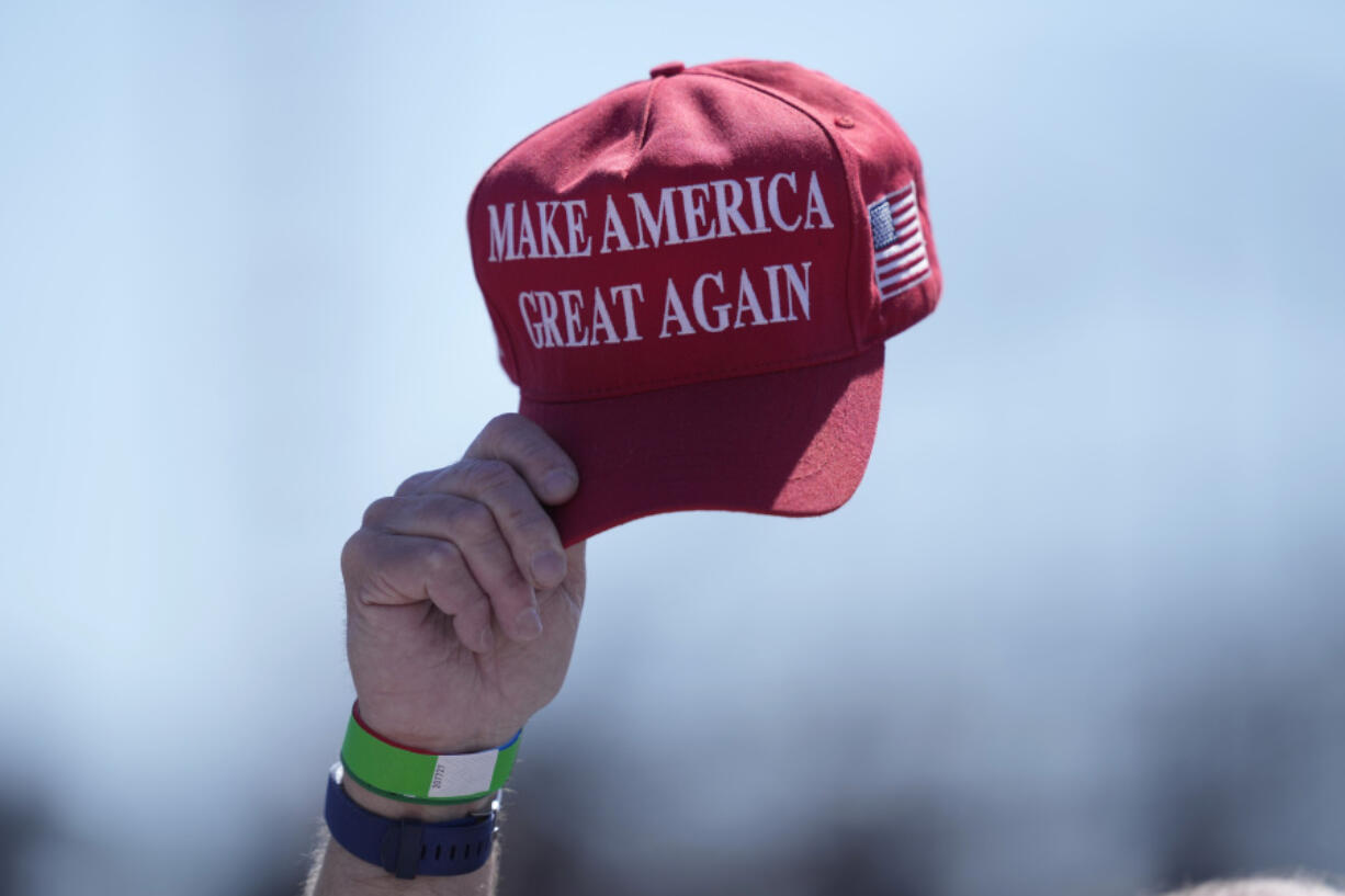 FILE - An attendee waves a hat ahead of a campaign rally for Republican presidential candidate former President Donald Trump in Wildwood, N.J., on May 11, 2024. Trump&rsquo;s presidential campaign will begin accepting donations in cryptocurrency, the presumptive Republican presidential nominee&rsquo;s campaign says.