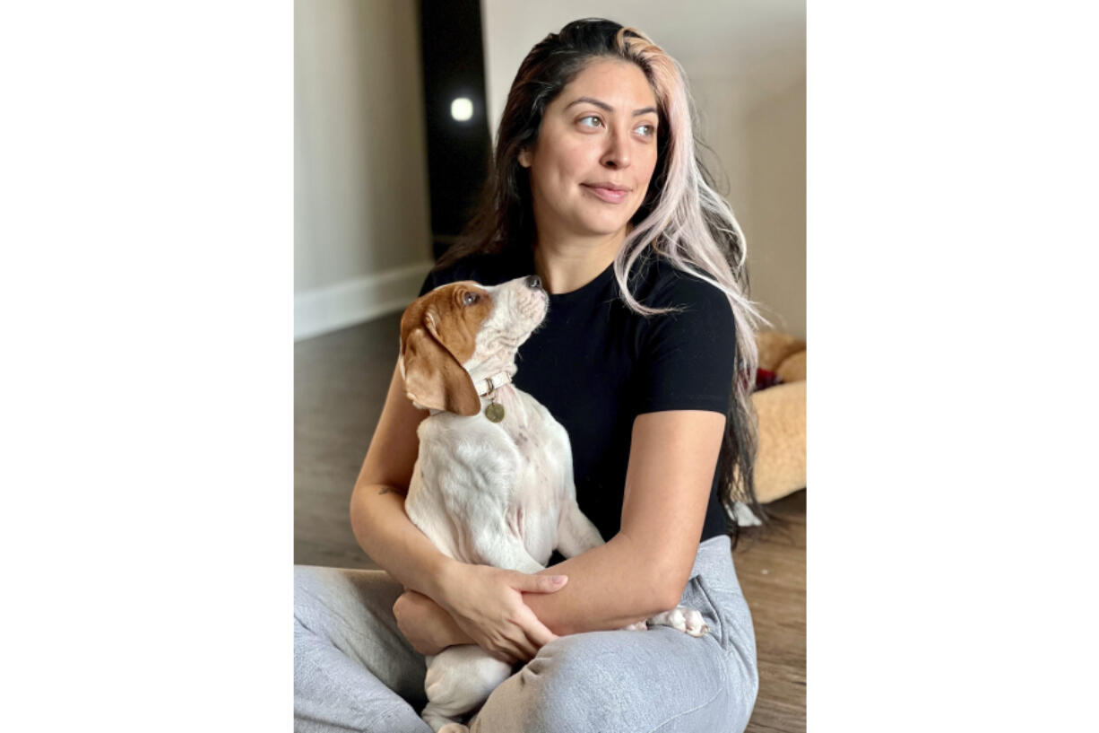 Kristie Pereira and her dog, Beau, pose for a photo in Laurel, Md., in January 2023. Pereira is seeking answers after the sick dog she took to a shelter to have euthanized turned up more than a year later on a rescue adoption site.